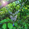 Vintage floral Silver butterfly pendant necklace with Swarovski rhinestones and a blue baroque Maple leaf shaped drop crystal.