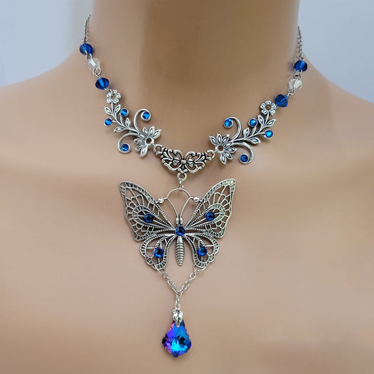 Vintage floral Silver butterfly pendant necklace with Swarovski rhinestones and a blue baroque Maple leaf shaped drop crystal.