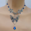 Vintage floral Silver butterfly pendant necklace with Swarovski rhinestones and a blue baroque Maple leaf shaped drop crystal.